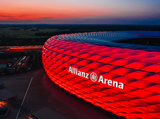 Allianz Arena illuminated in red during sunset