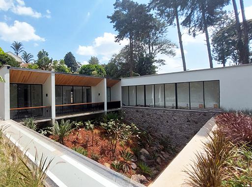 modern courtyard home in nairobi with large glass windows and landscaped garden