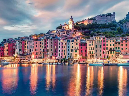 colorful waterfront buildings at sunset in portovenere, italy